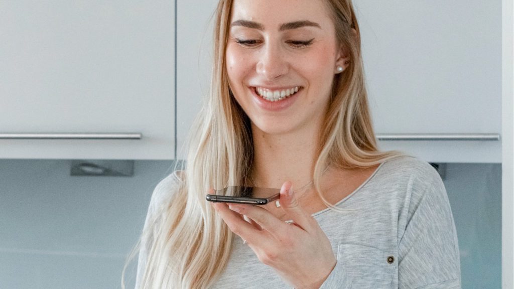 woman smiling talking to phone while AI messure the sympathy